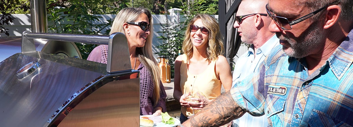 Friends grilling at outdoor kitchen