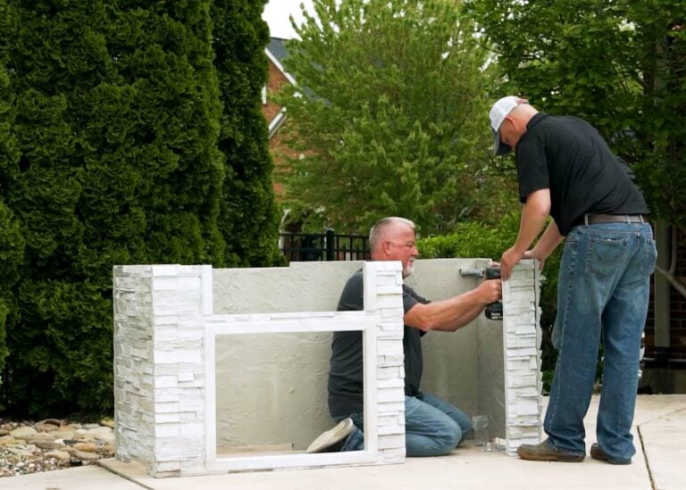 two people easily putting together a ready to assemble outdoor kitchen grill island