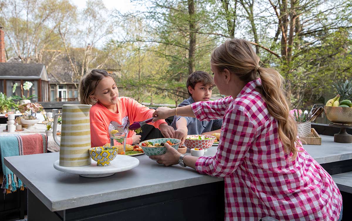 tamara day serving her kids at her outdoor kitchen bar seating