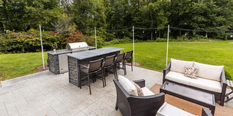 stacked stone galley style outdoor kitchen