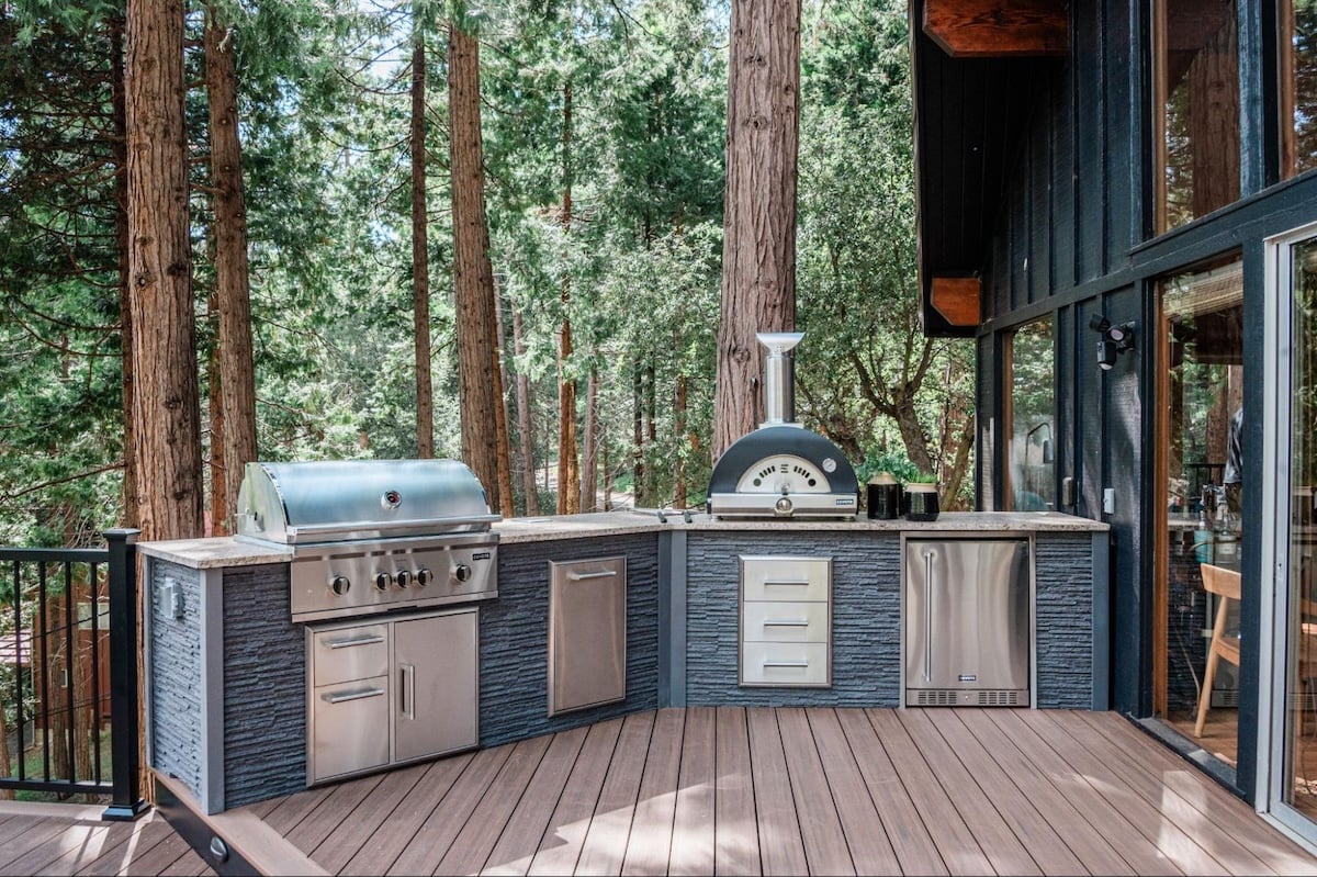 modern stone outdoor kitchen on deck at cabin home