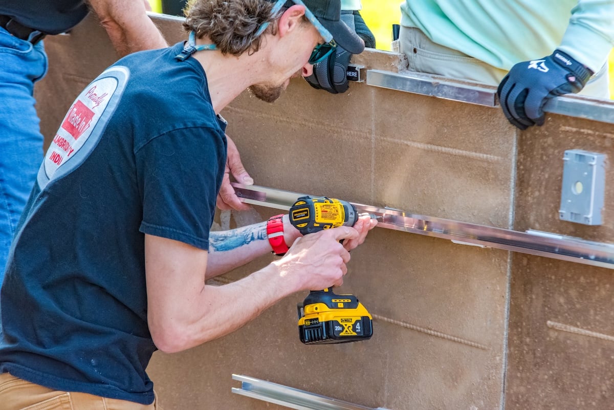 man installing outdoor kitchen