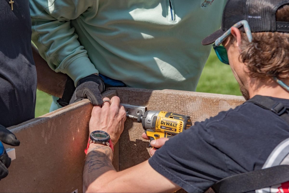 man installing outdoor kitchen