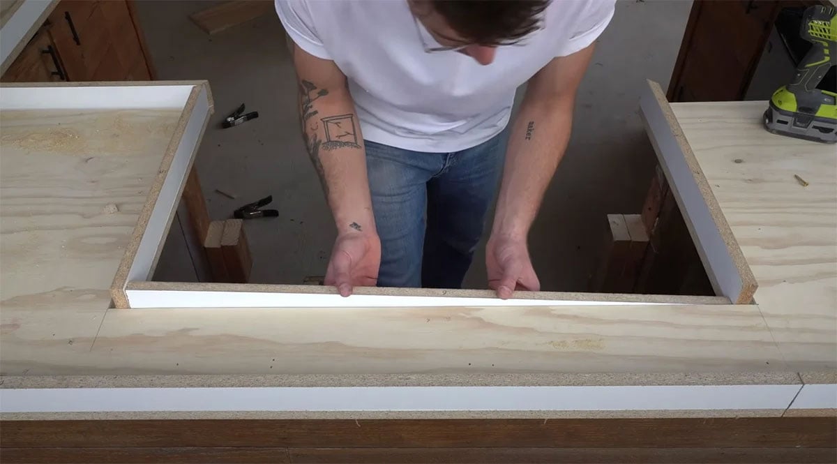 man preparing countertop surface for outdoor kitchen