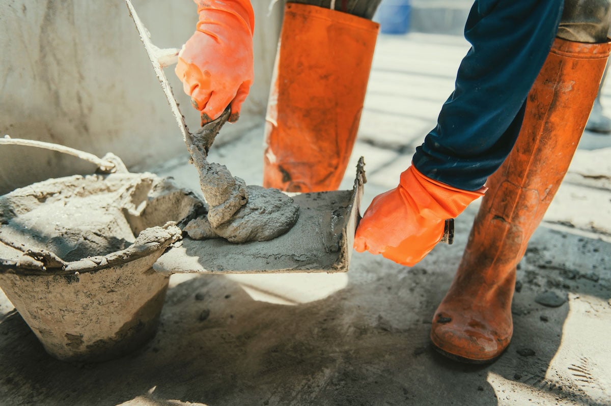 man putting stucco on trowel